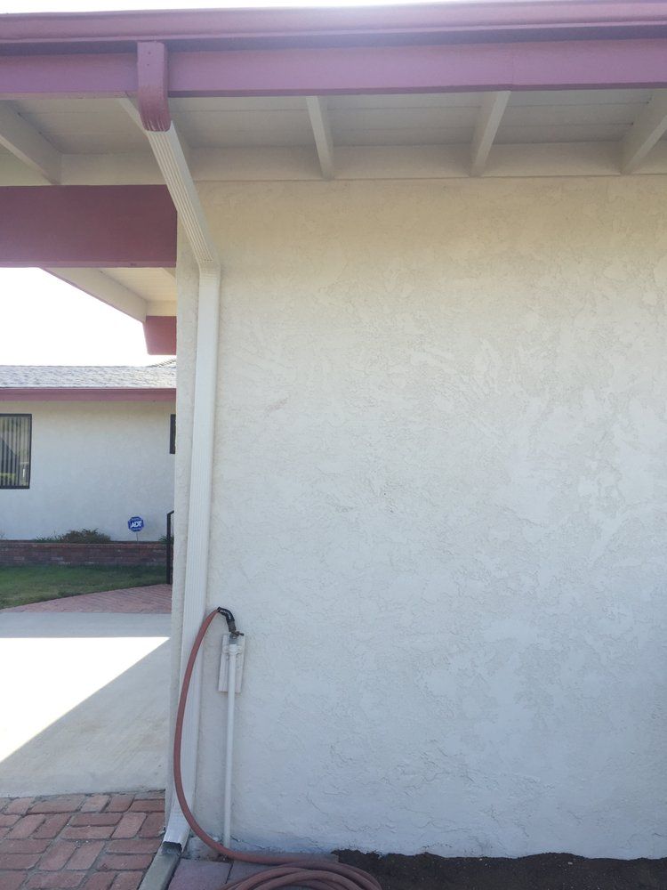 A hose is attached to the side of a house