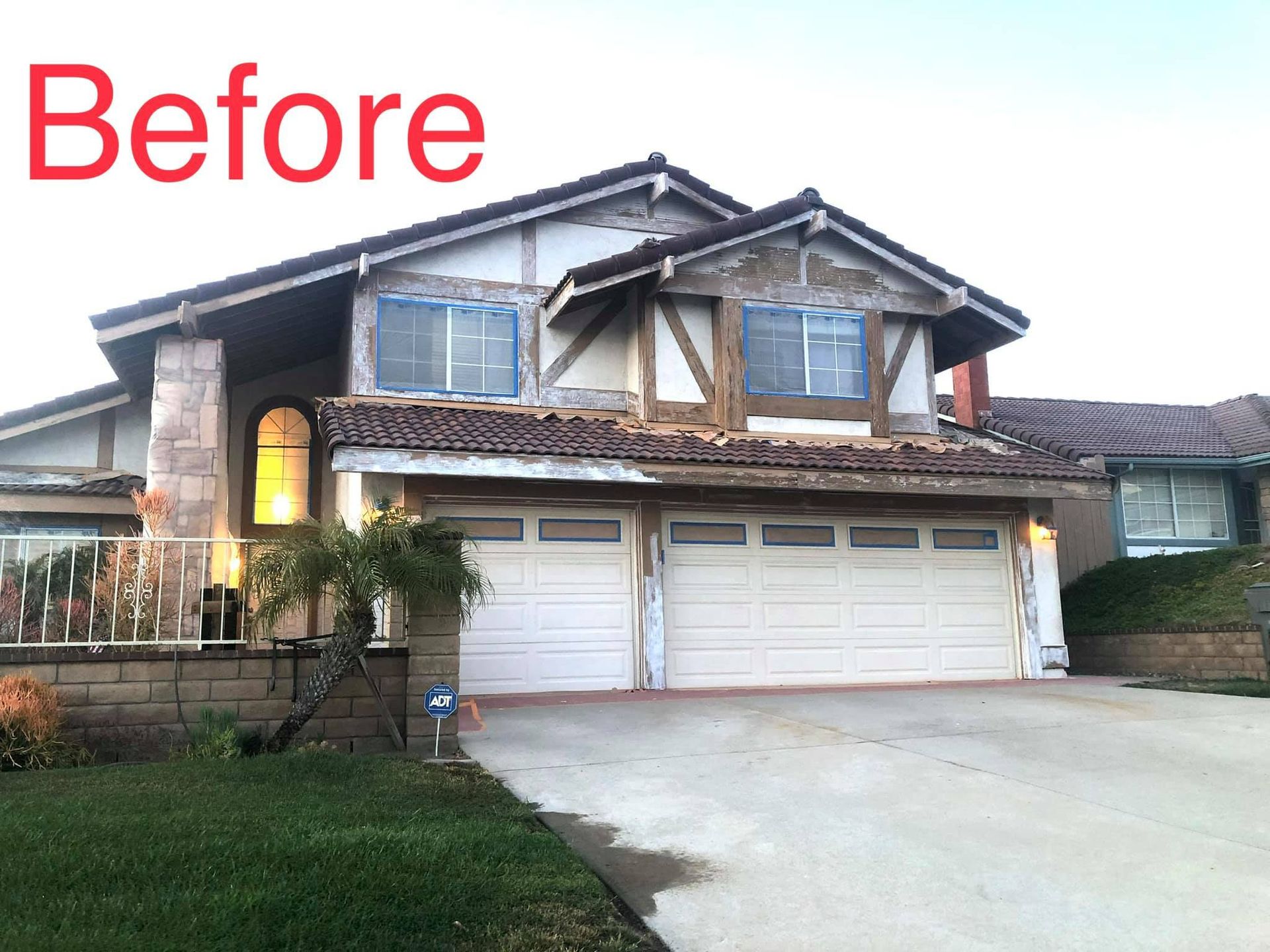 A before picture of a house with a white garage door