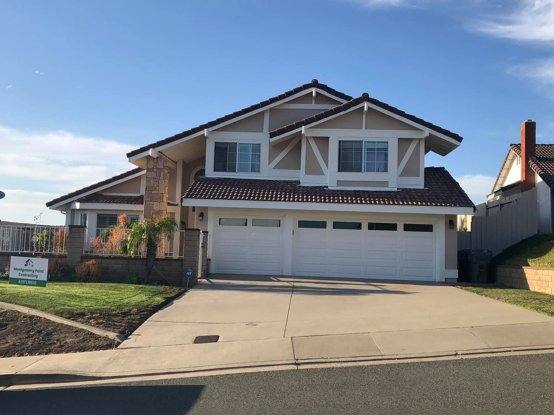 A large house with a sign in front of it that says