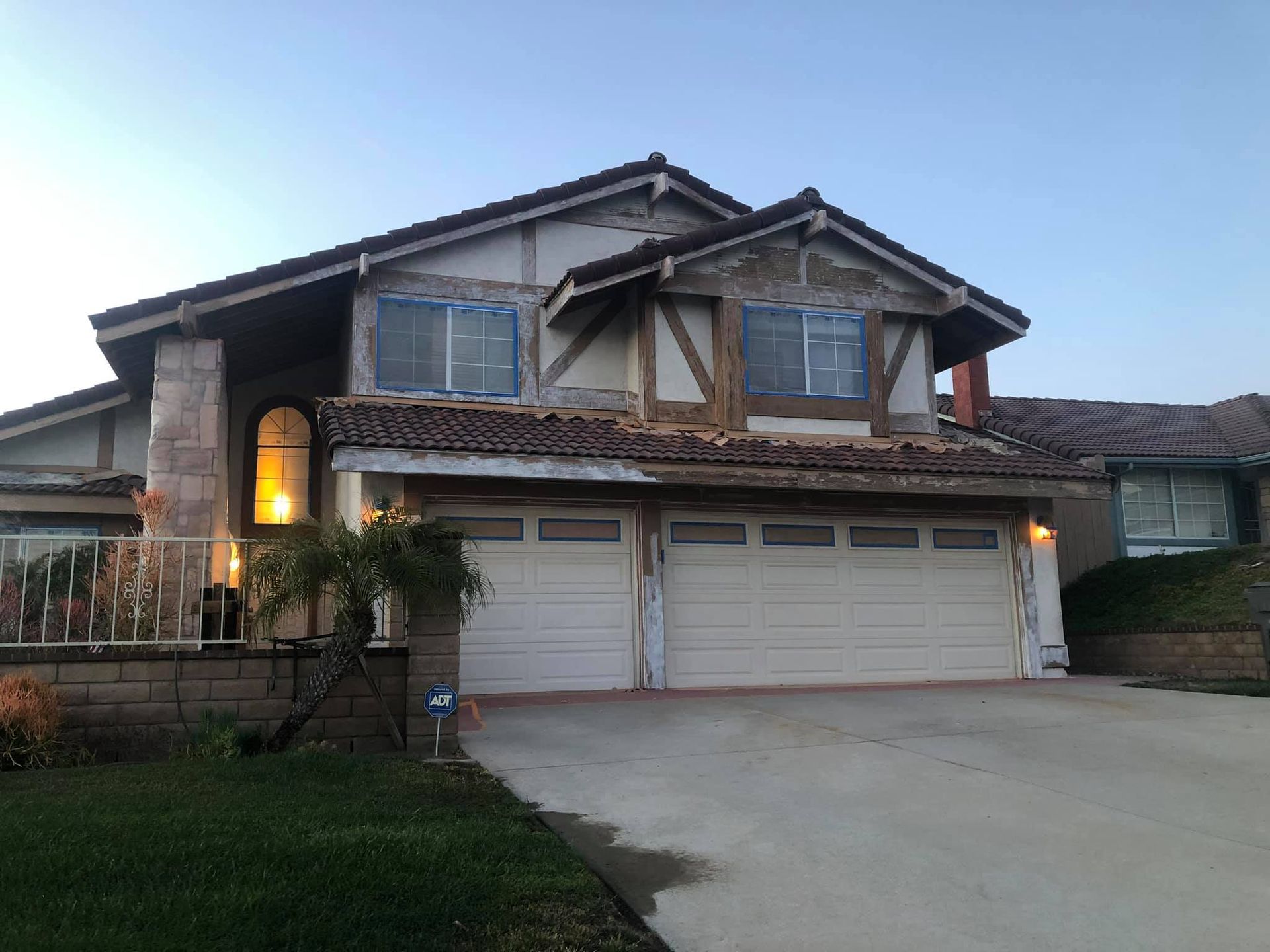A large house with two garage doors and a driveway