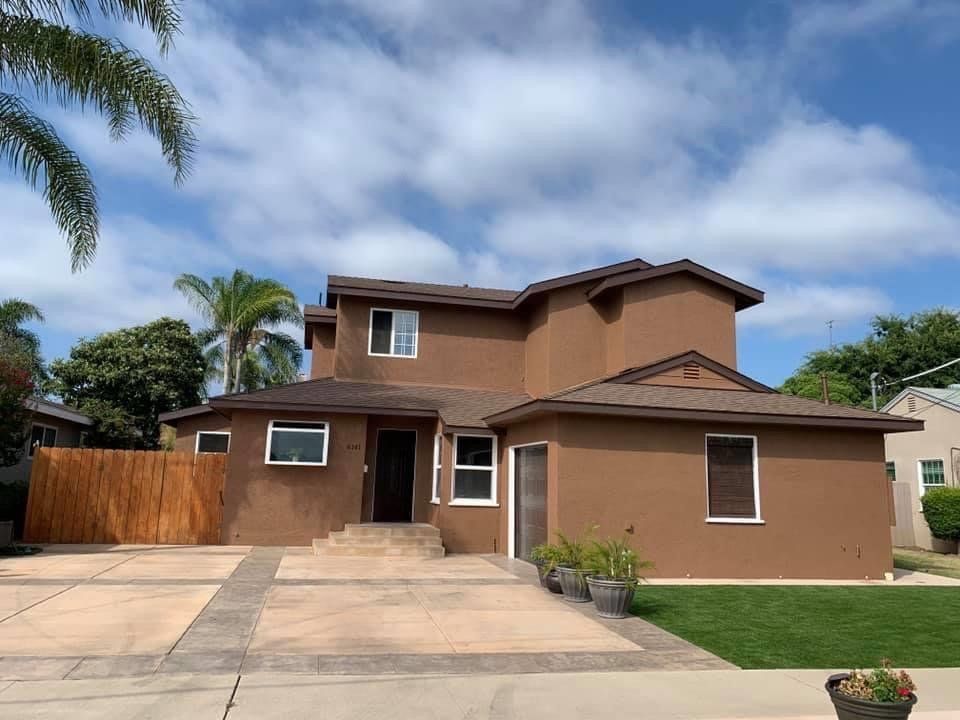 A large brown house with a lot of windows