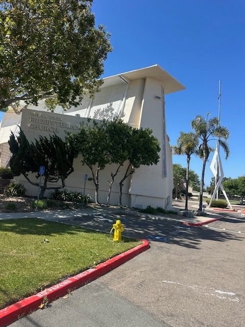 A large white building with a fire hydrant in front of it