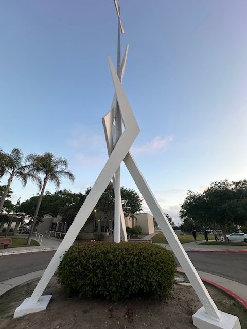 A large white sculpture with a blue sky in the background
