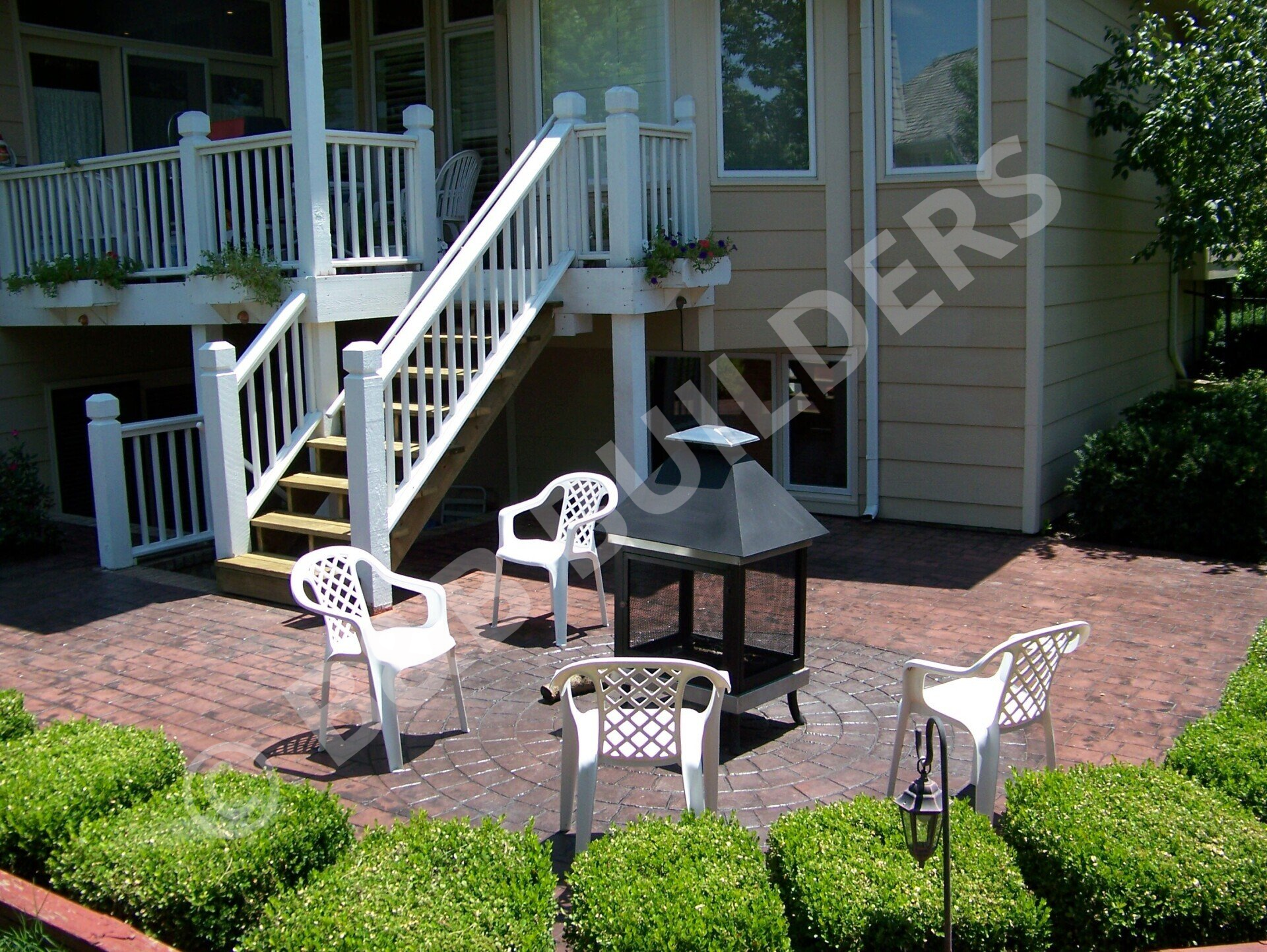 Brick and stamped concrete patio with metal firepit