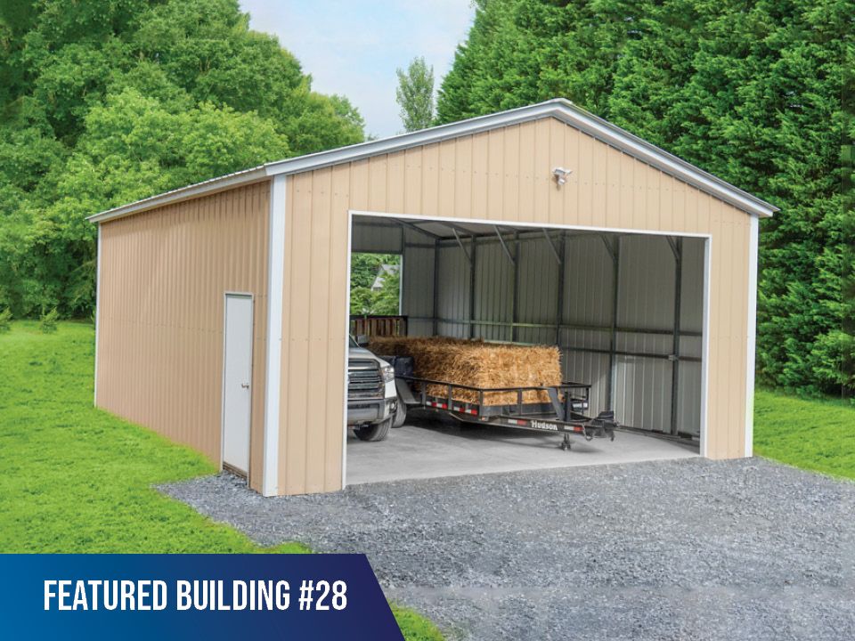 A metal garage with a trailer inside of it.