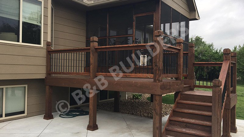 Two story wooden deck with screened area