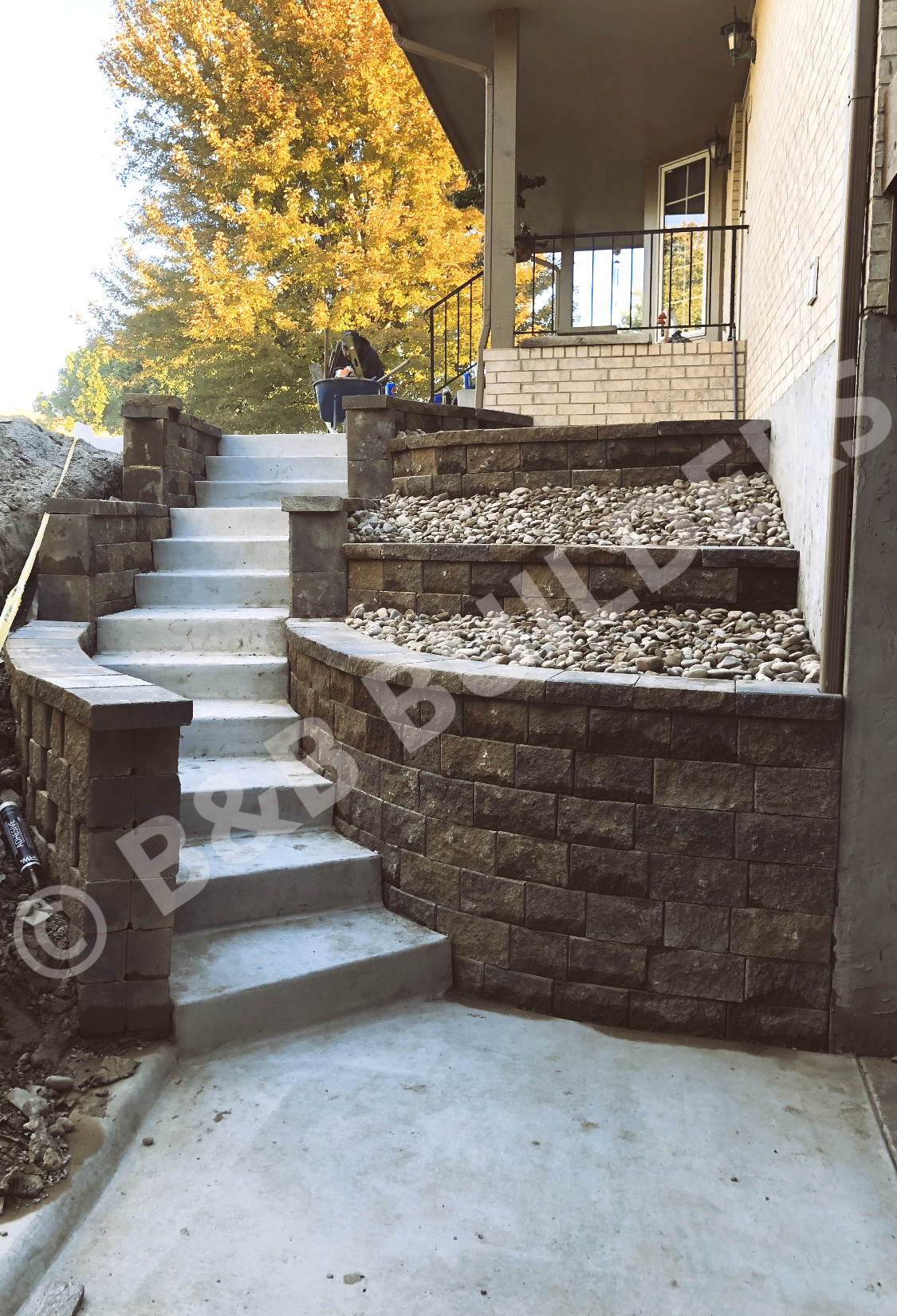 Curved concrete stairs with terraced masonry walls on either side