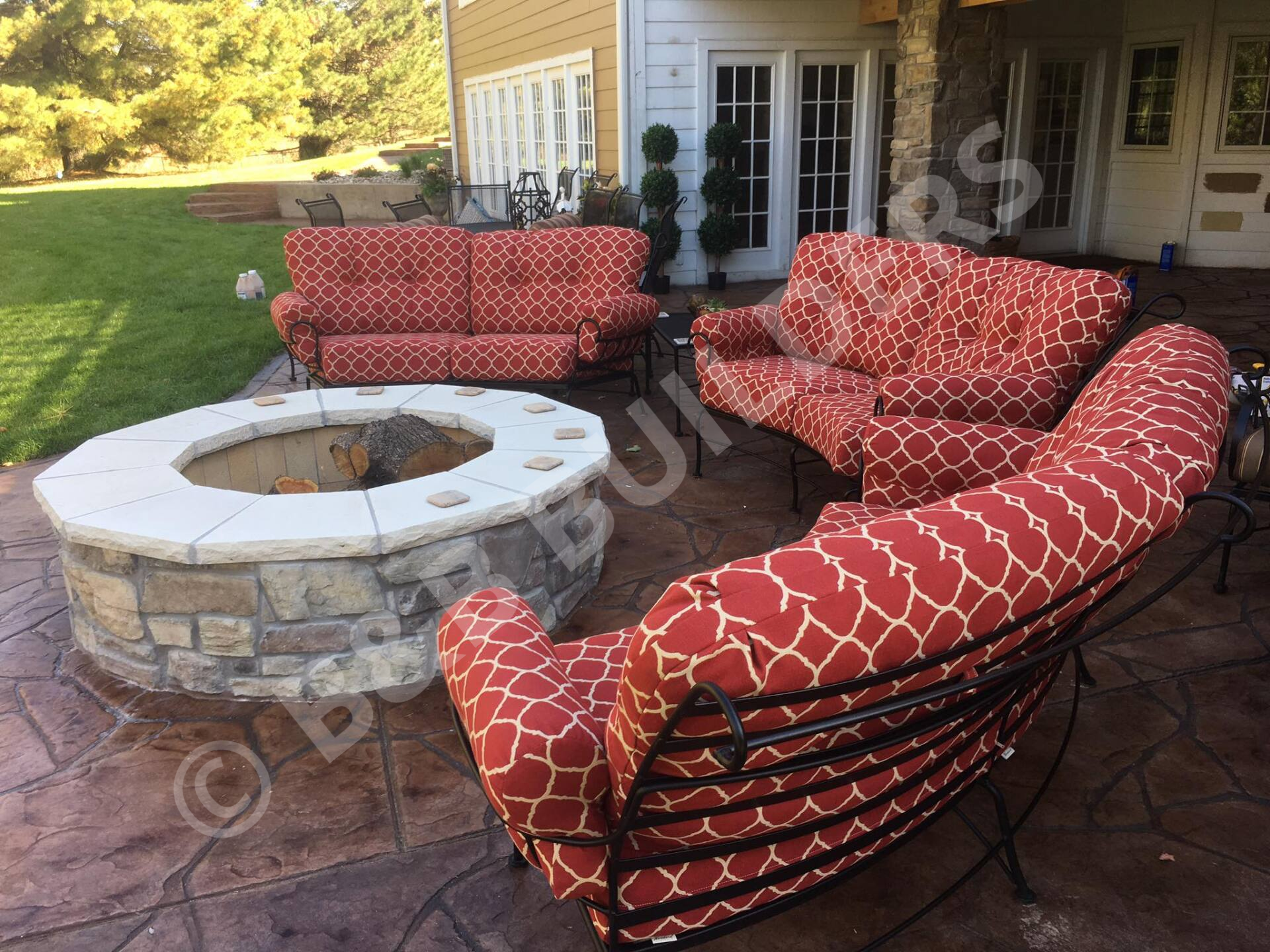 Masonry firepit surrounded by outdoor sofas