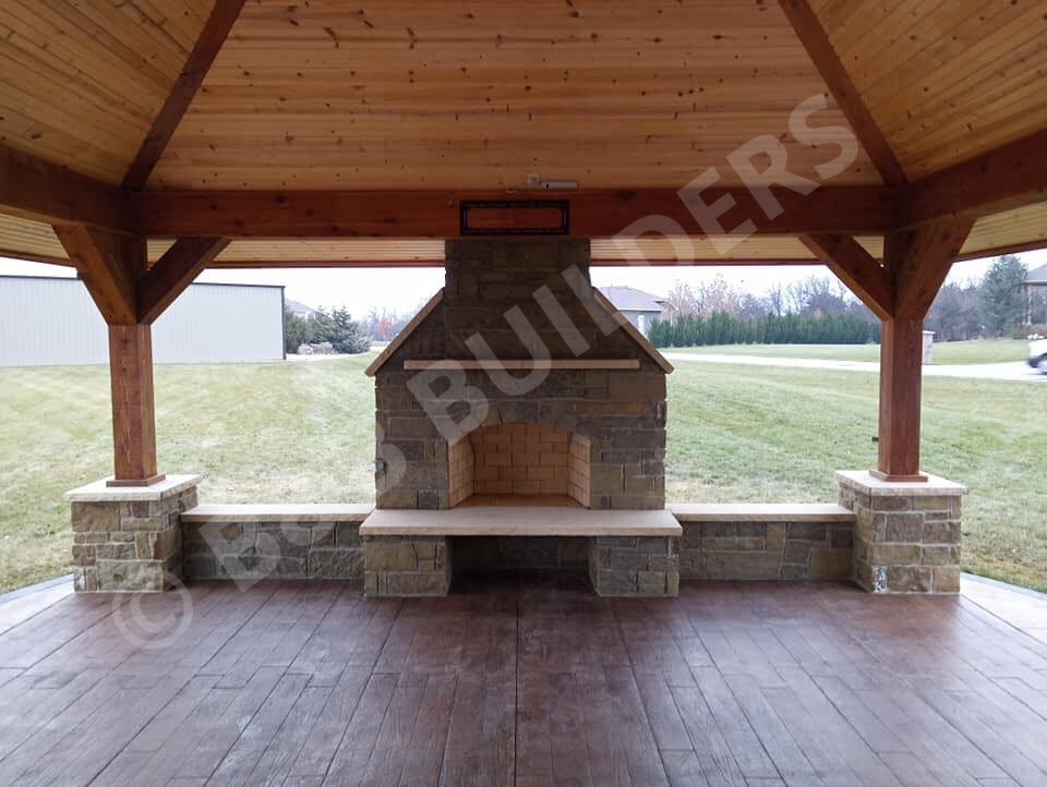 Covered concrete patio with masonry firpelace and sitting walls