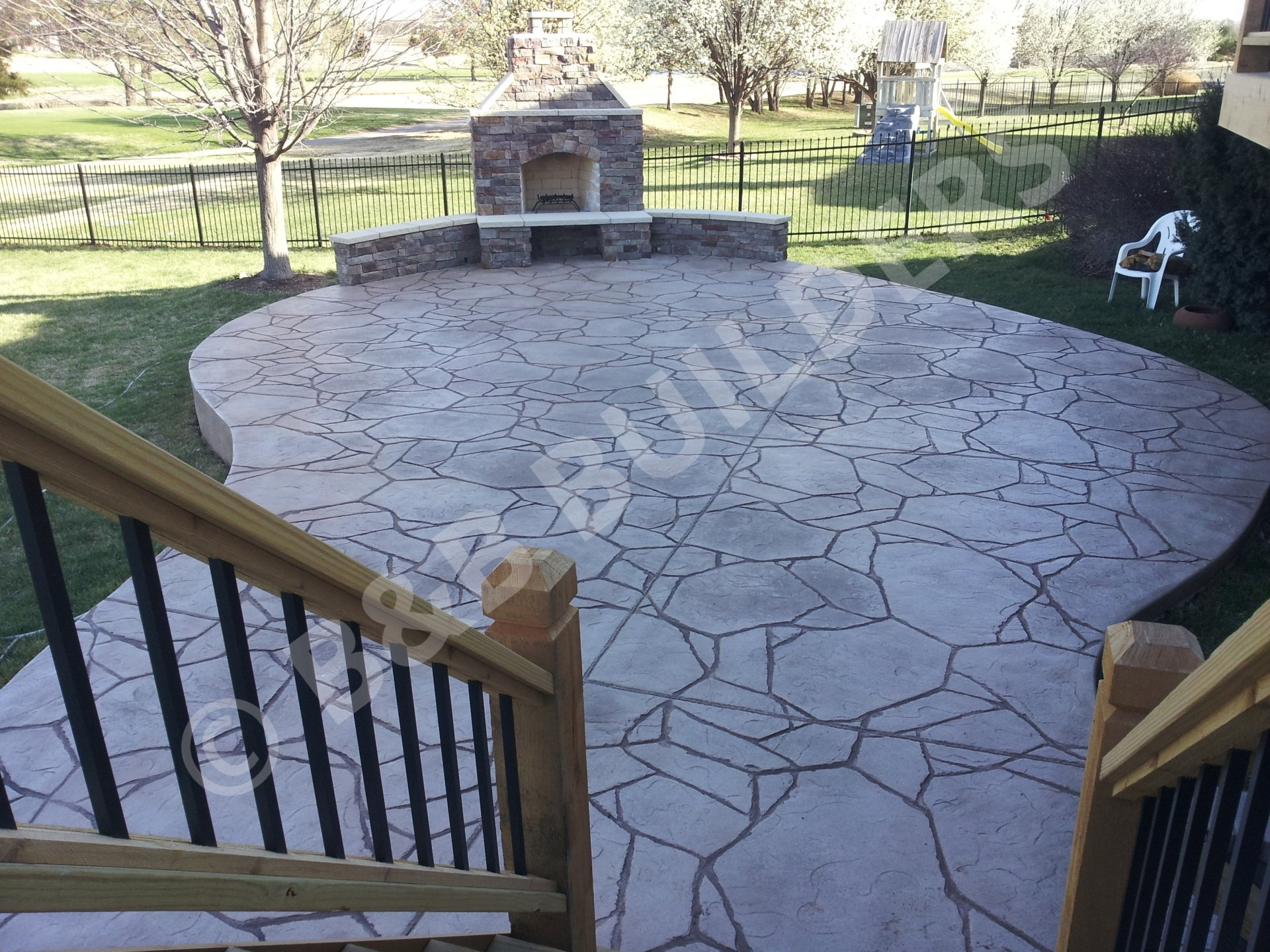 Stamped concrete patio with masonry fireplace