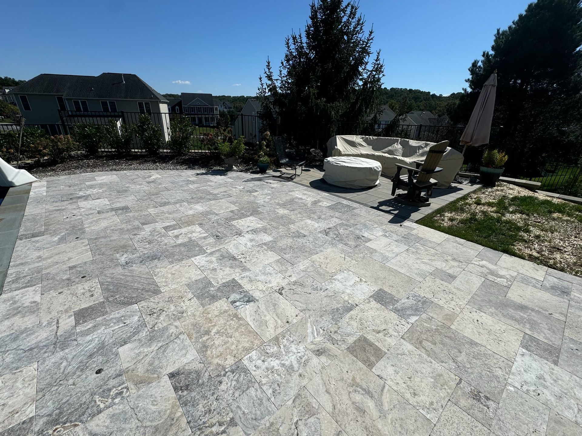 A patio with a couch and chairs on it