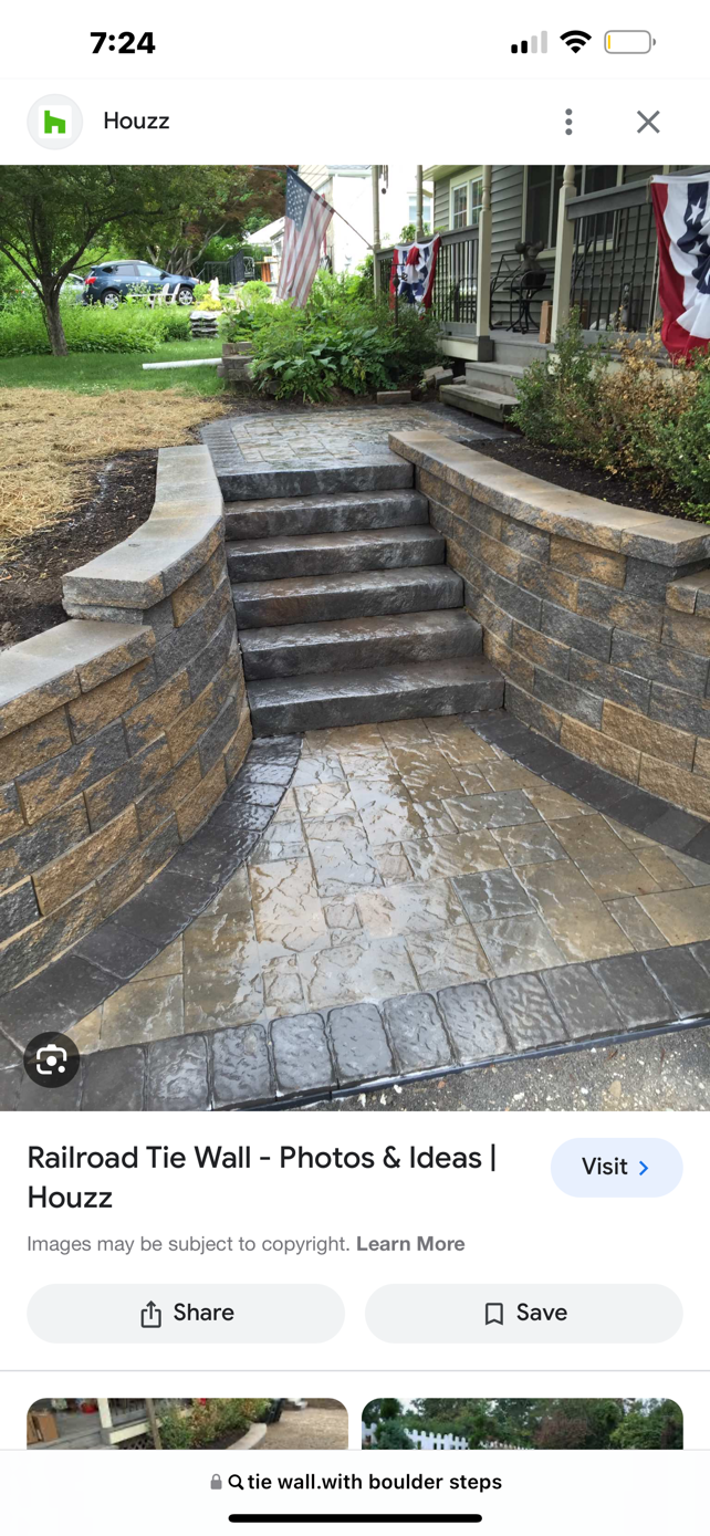 A picture of a stone wall and stairs on a cell phone.