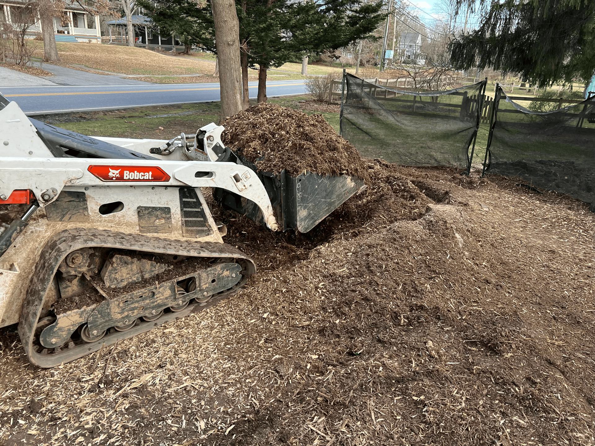 A white truck is parked in front of a large house.