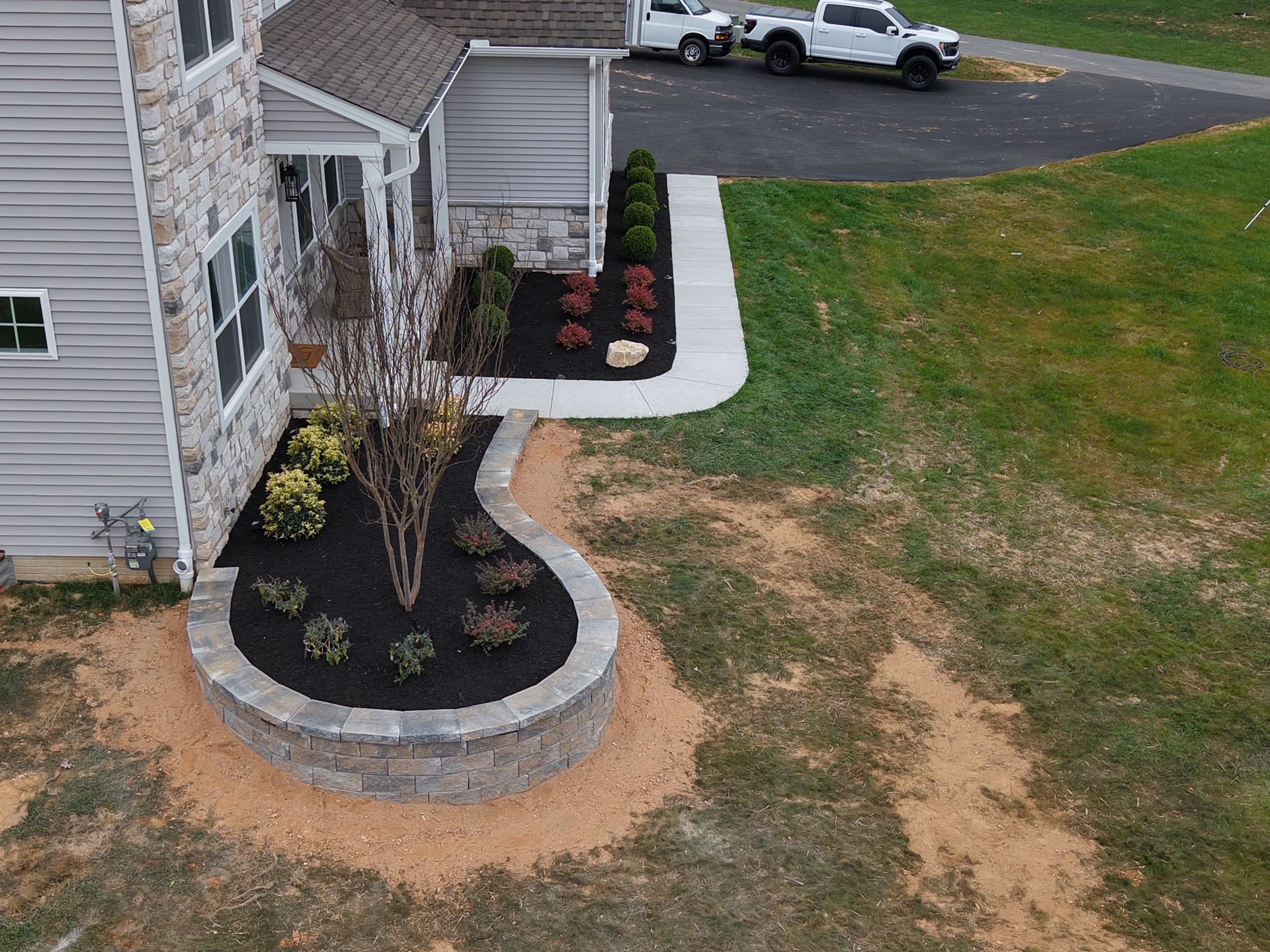 An aerial view of a house with a landscaping in front of it.