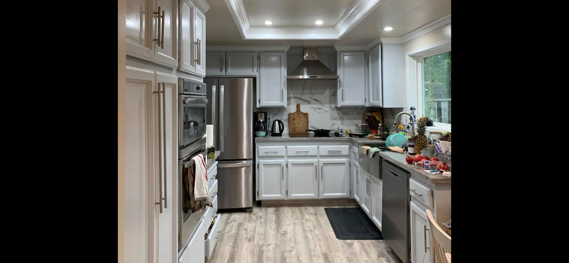 A kitchen with white cabinets and stainless steel appliances.