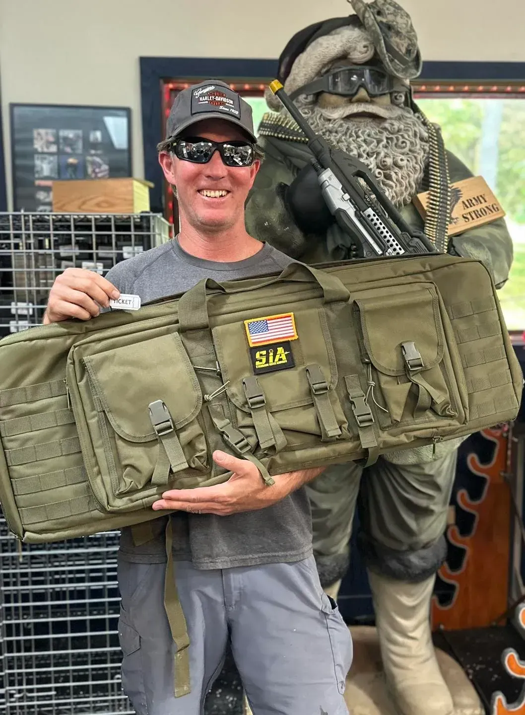 A man in a yellow vest is adjusting a thermostat while holding a tablet.
