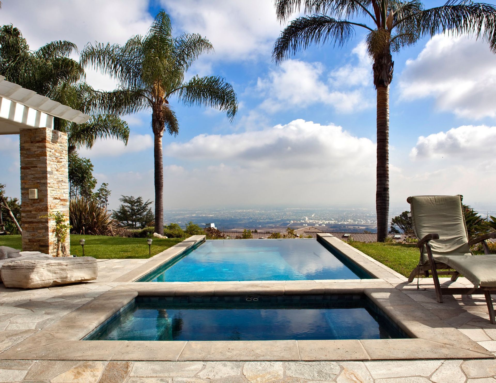 A large swimming pool with palm trees in the background