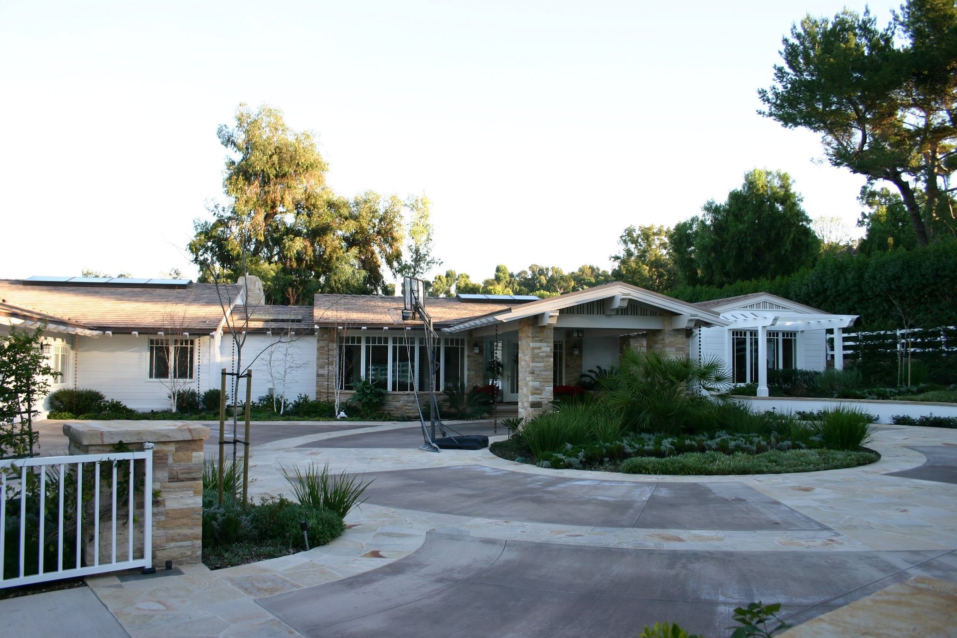 A large white house with a driveway leading to it