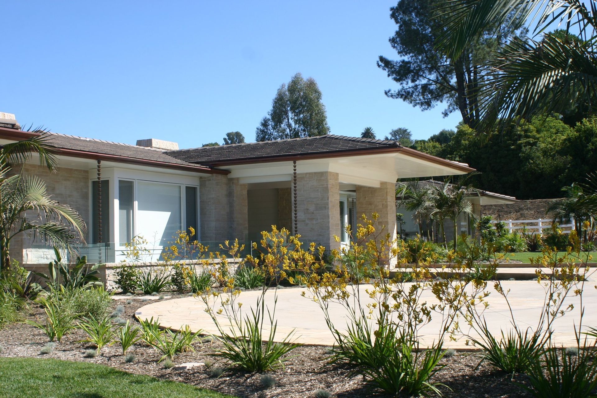A house with a lot of plants in front of it