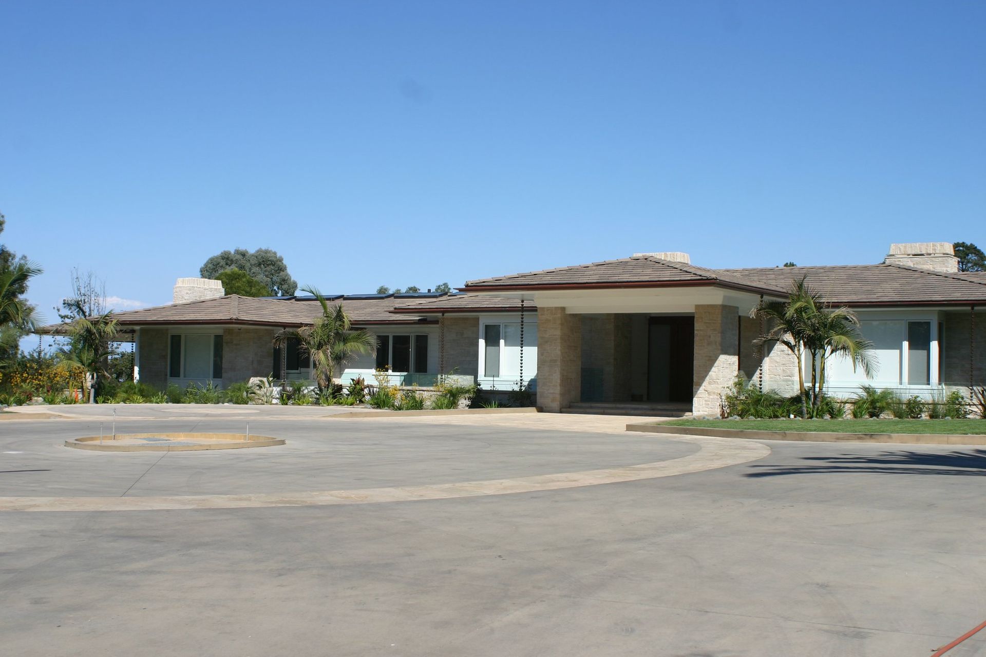 A large house with a parking lot in front of it
