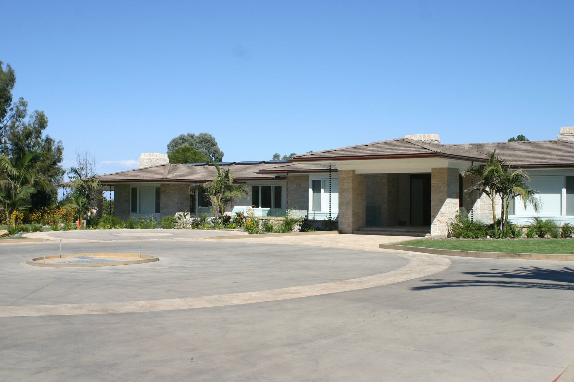 A large house with a circular driveway in front of it