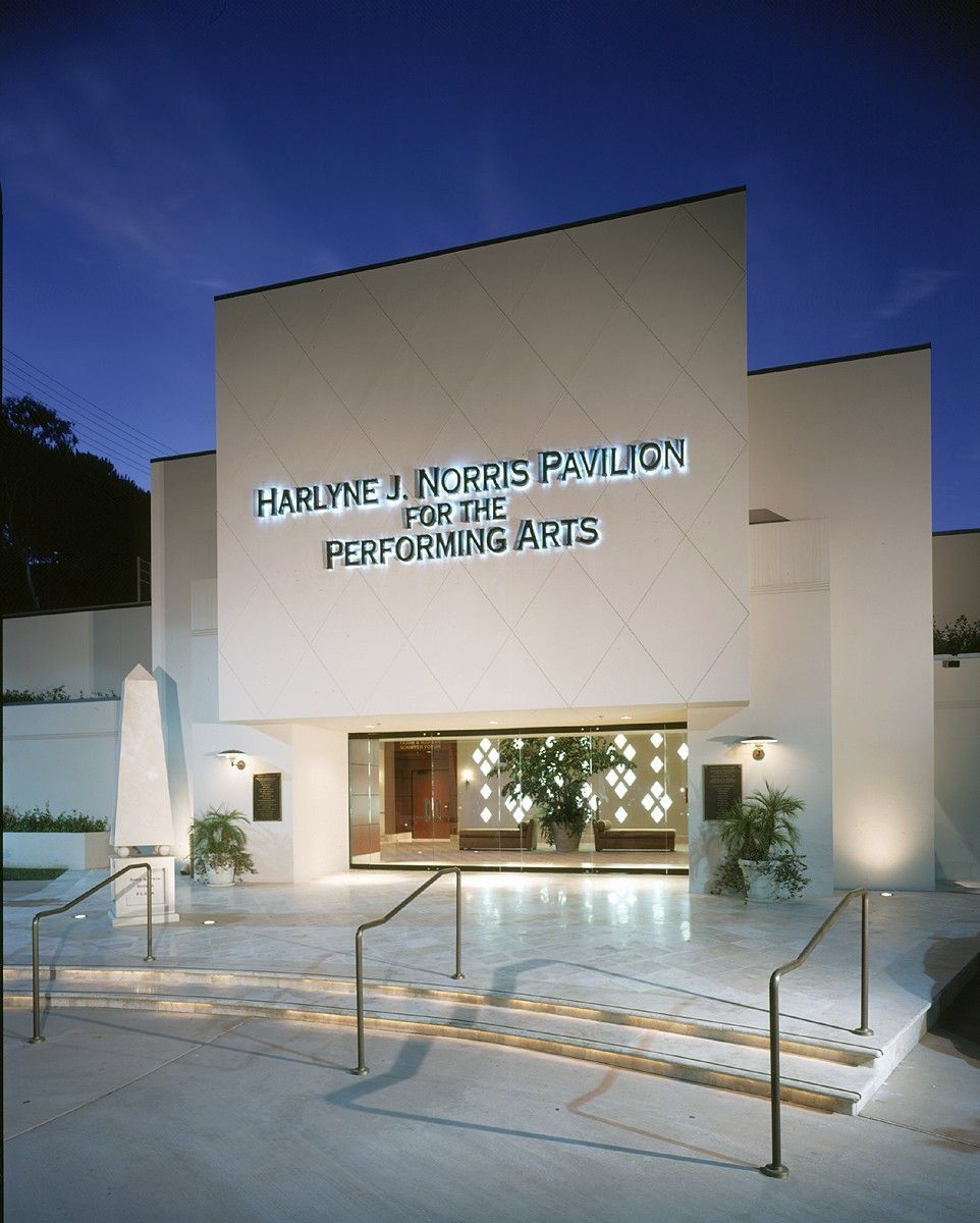 A white building with the words performing arts on it