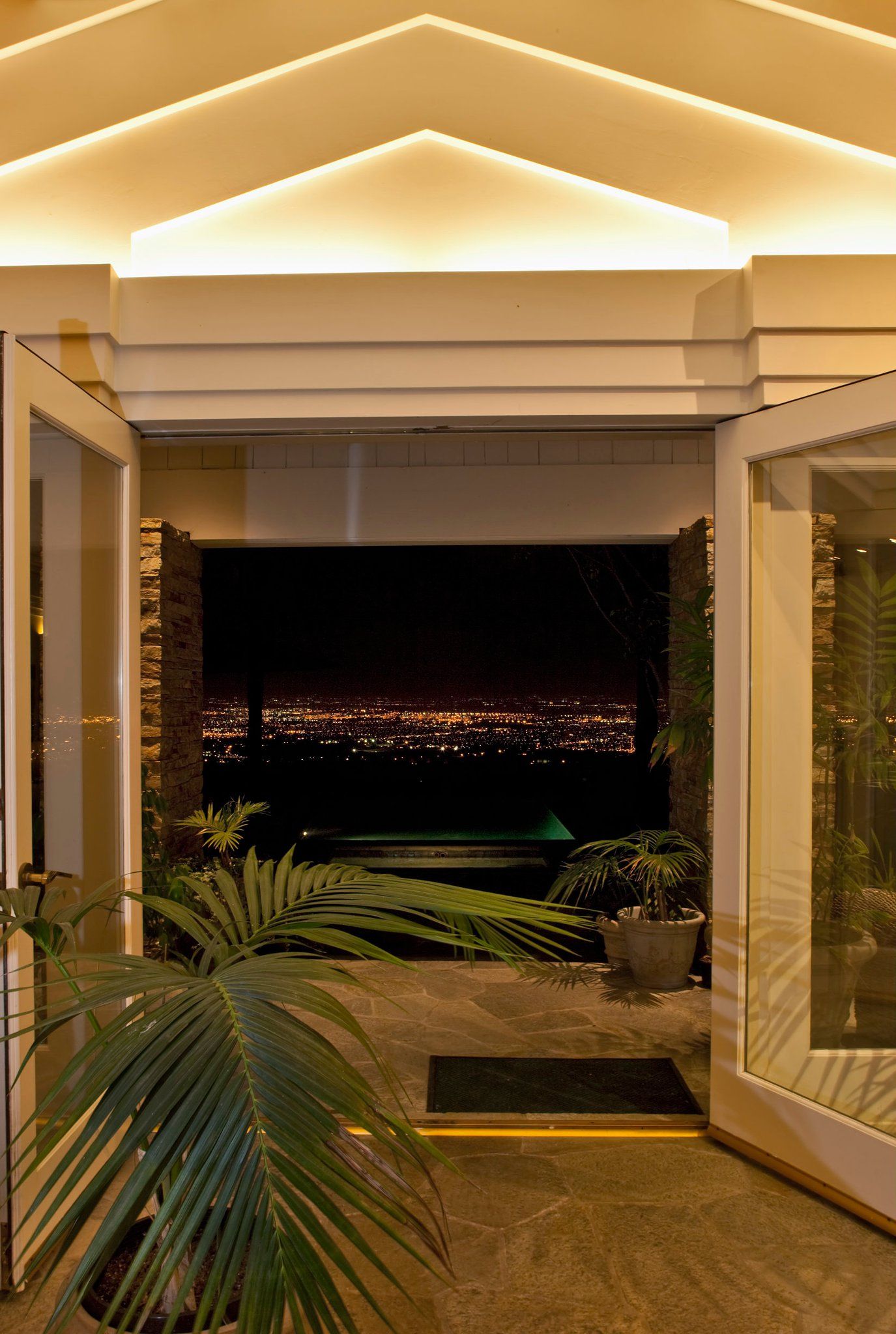 A hallway with a view of a city at night.