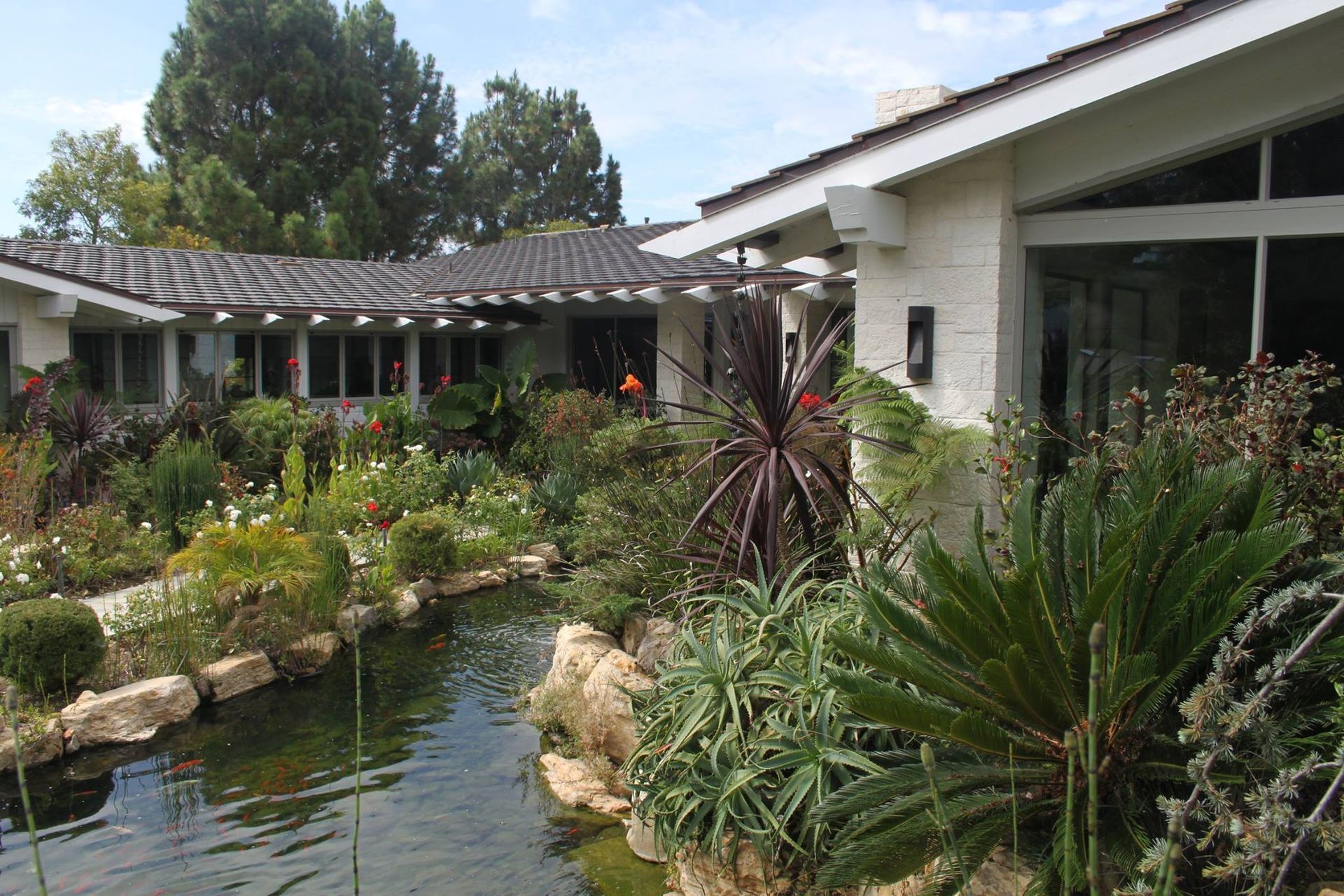 A house with a pond in front of it