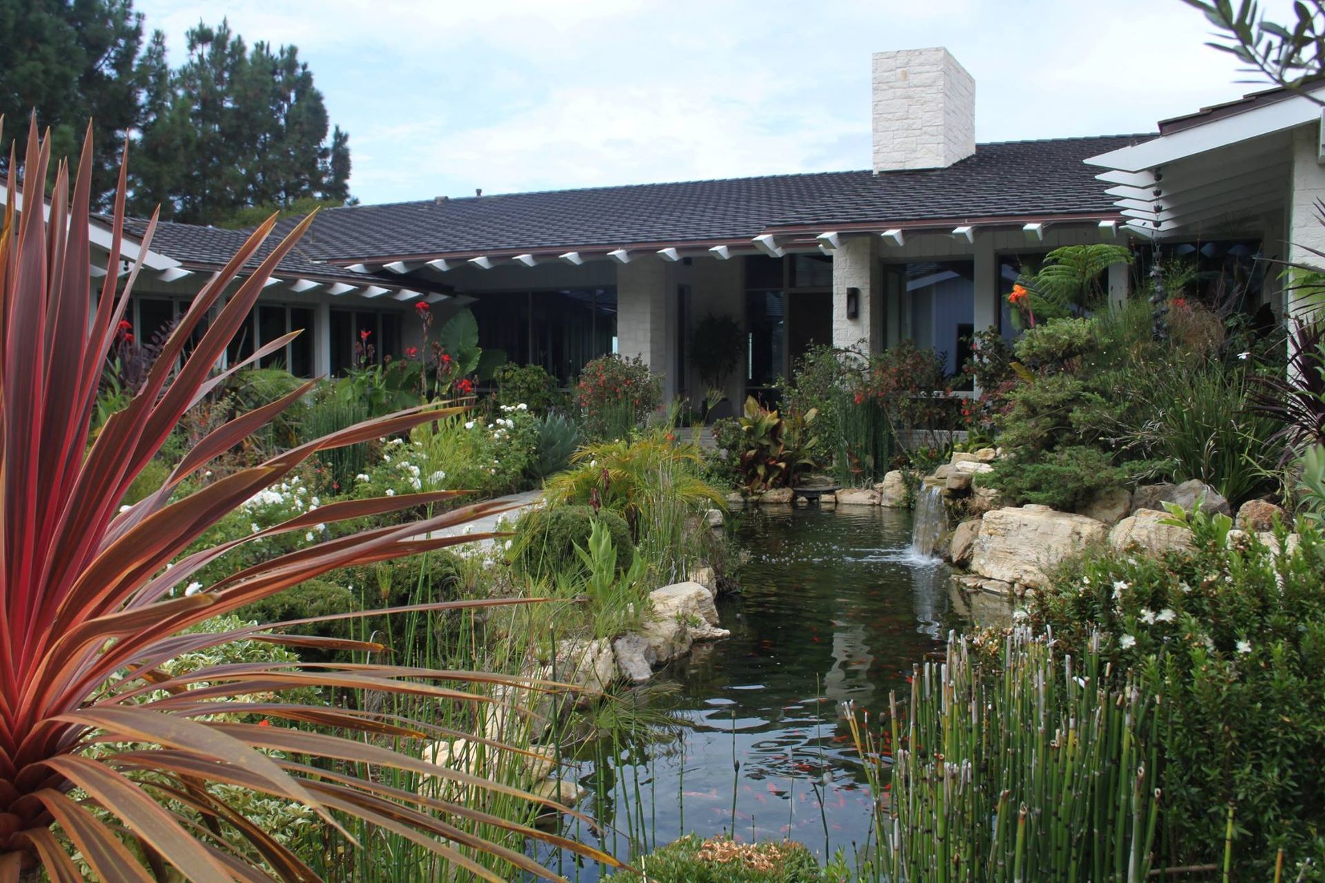A large house with a pond in front of it
