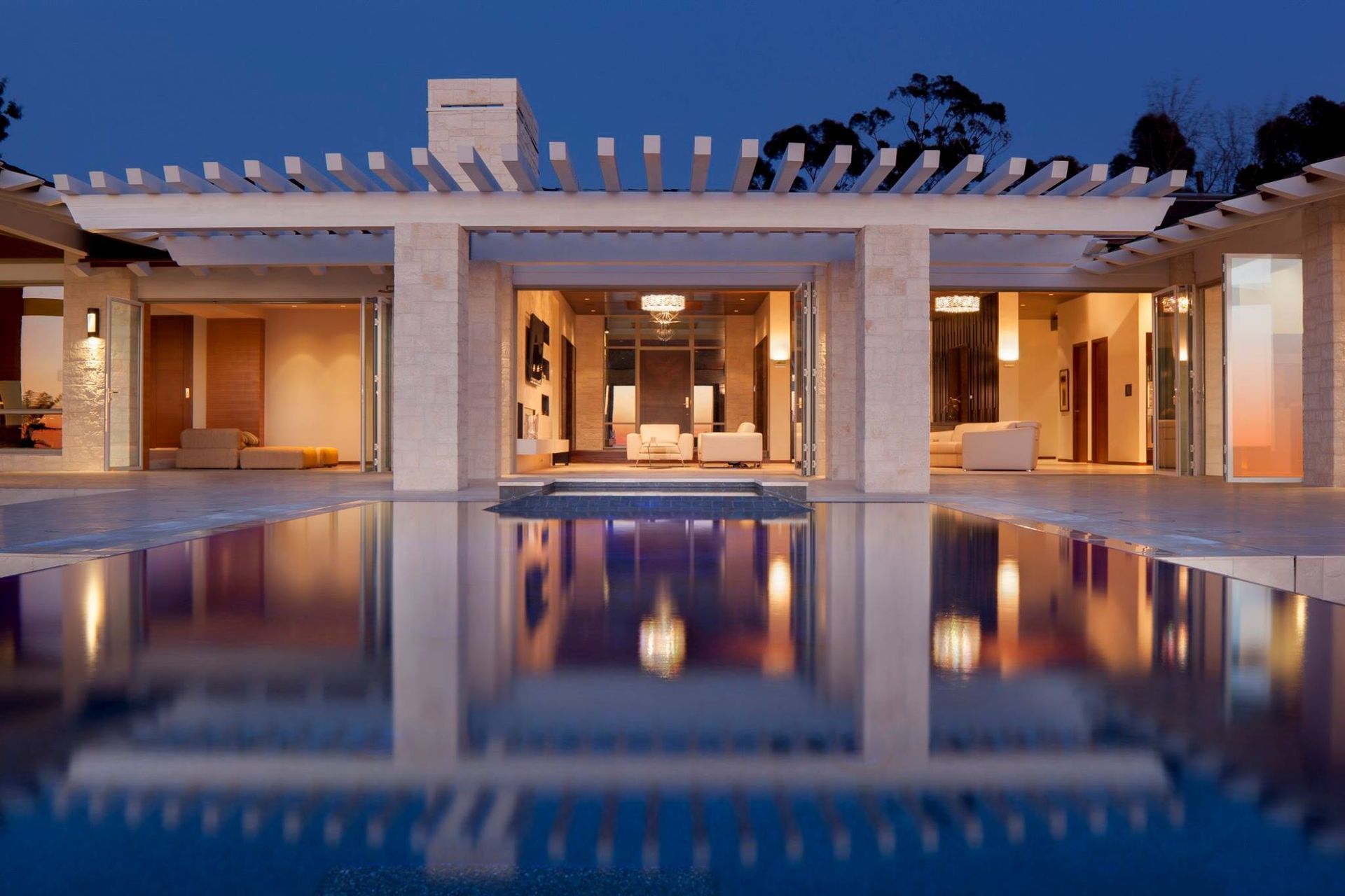 A large house with a swimming pool in front of it