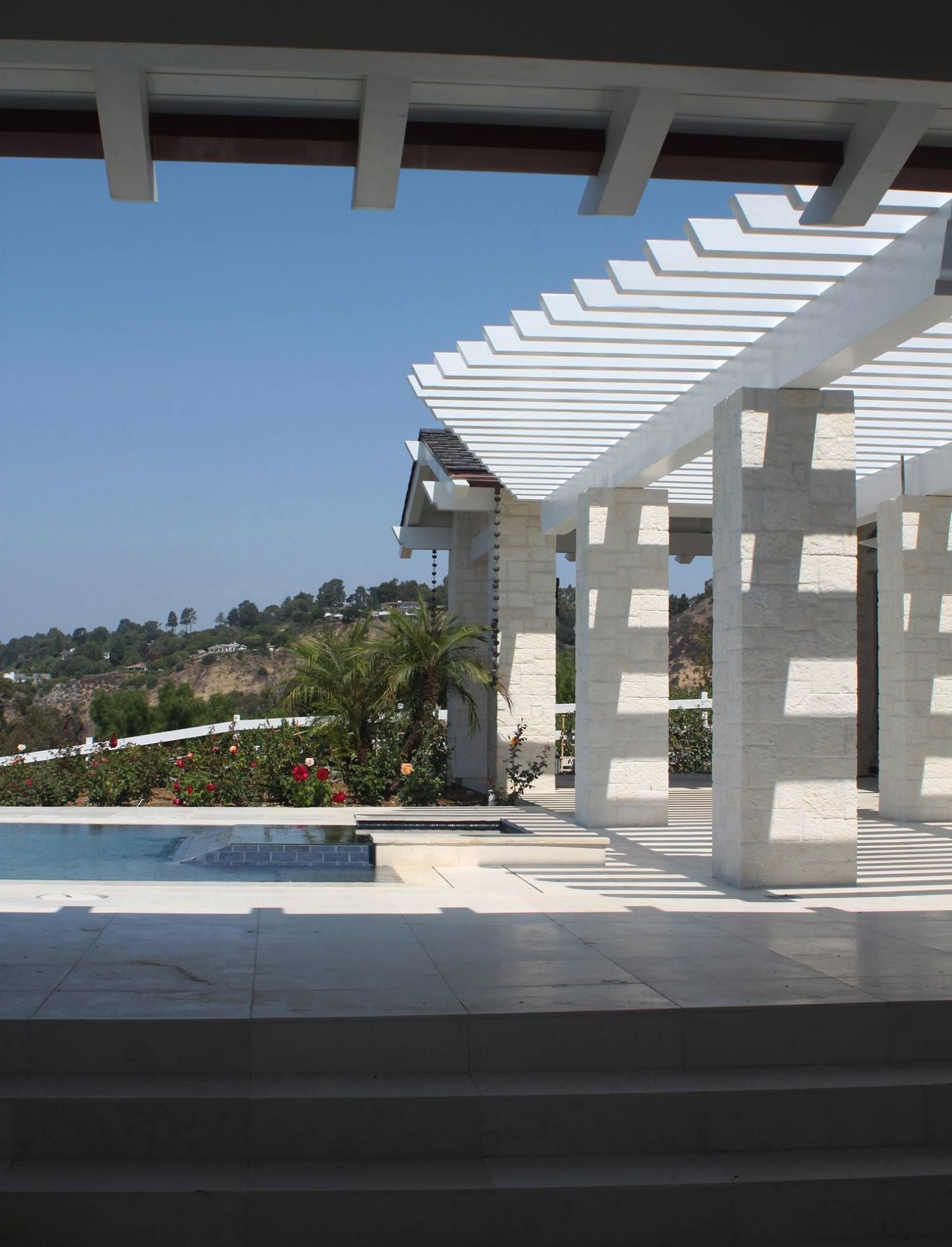 A view of a pergola overlooking a swimming pool