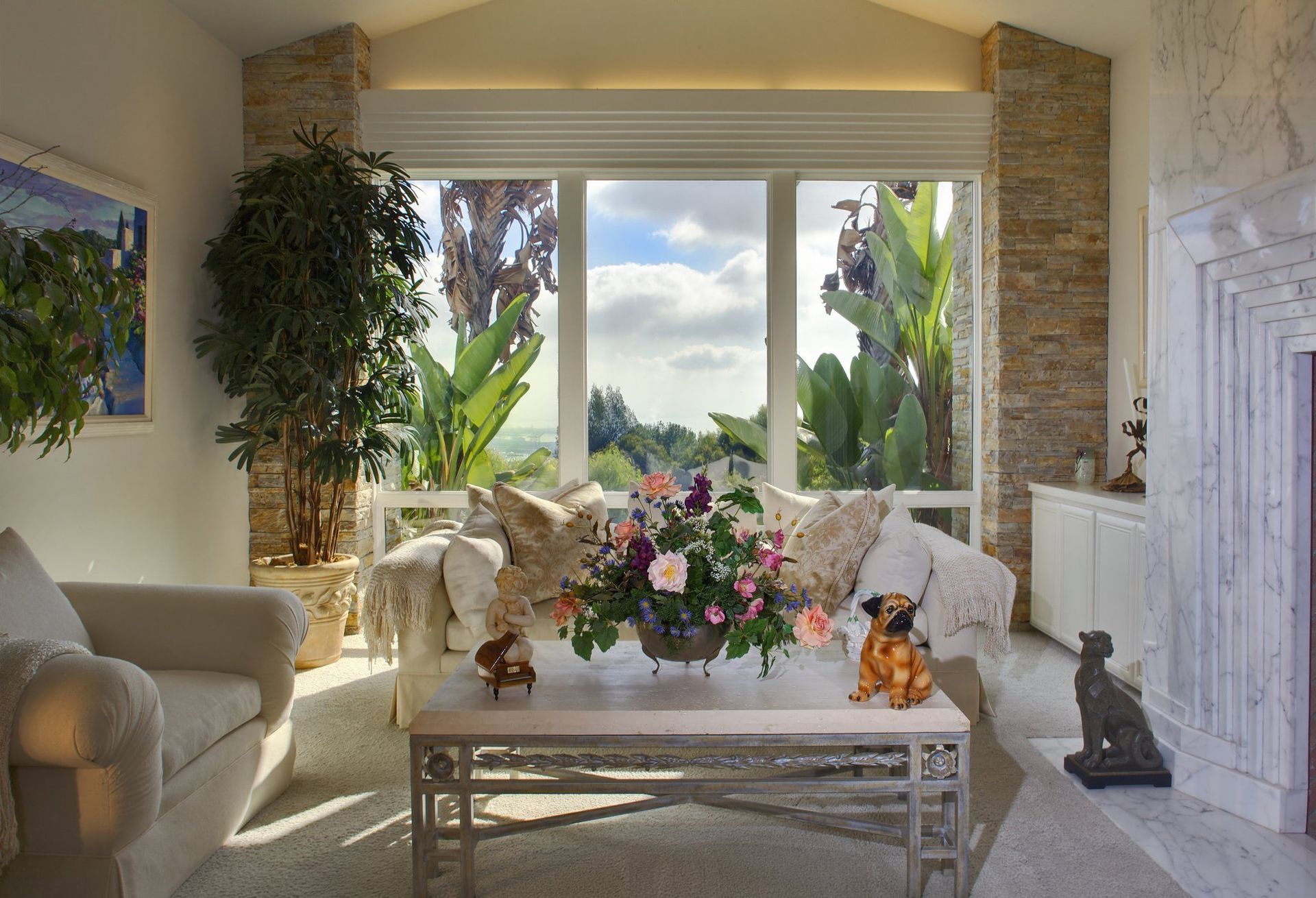 A living room with a couch a table and a fireplace