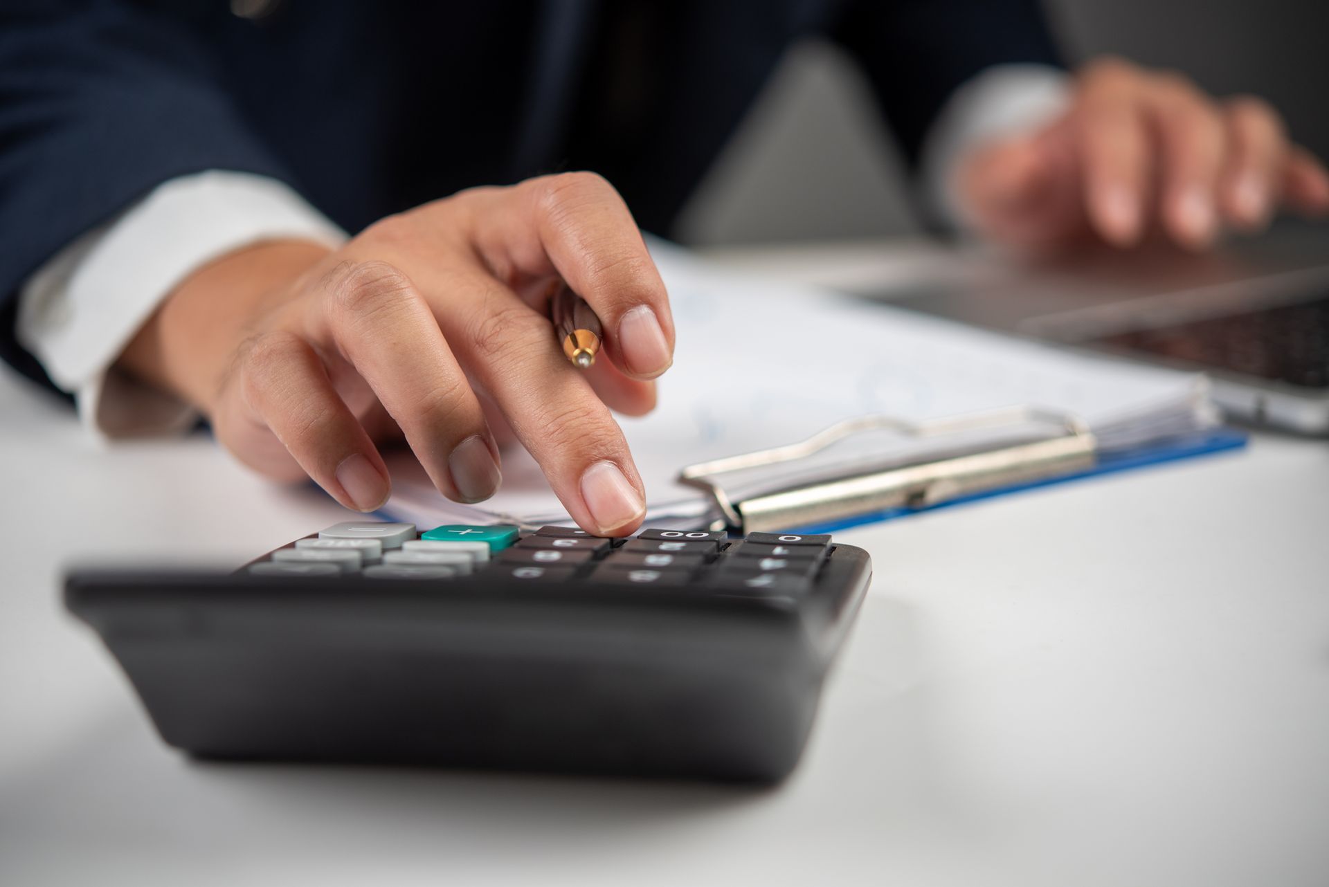 A close up of a person using a calculator.