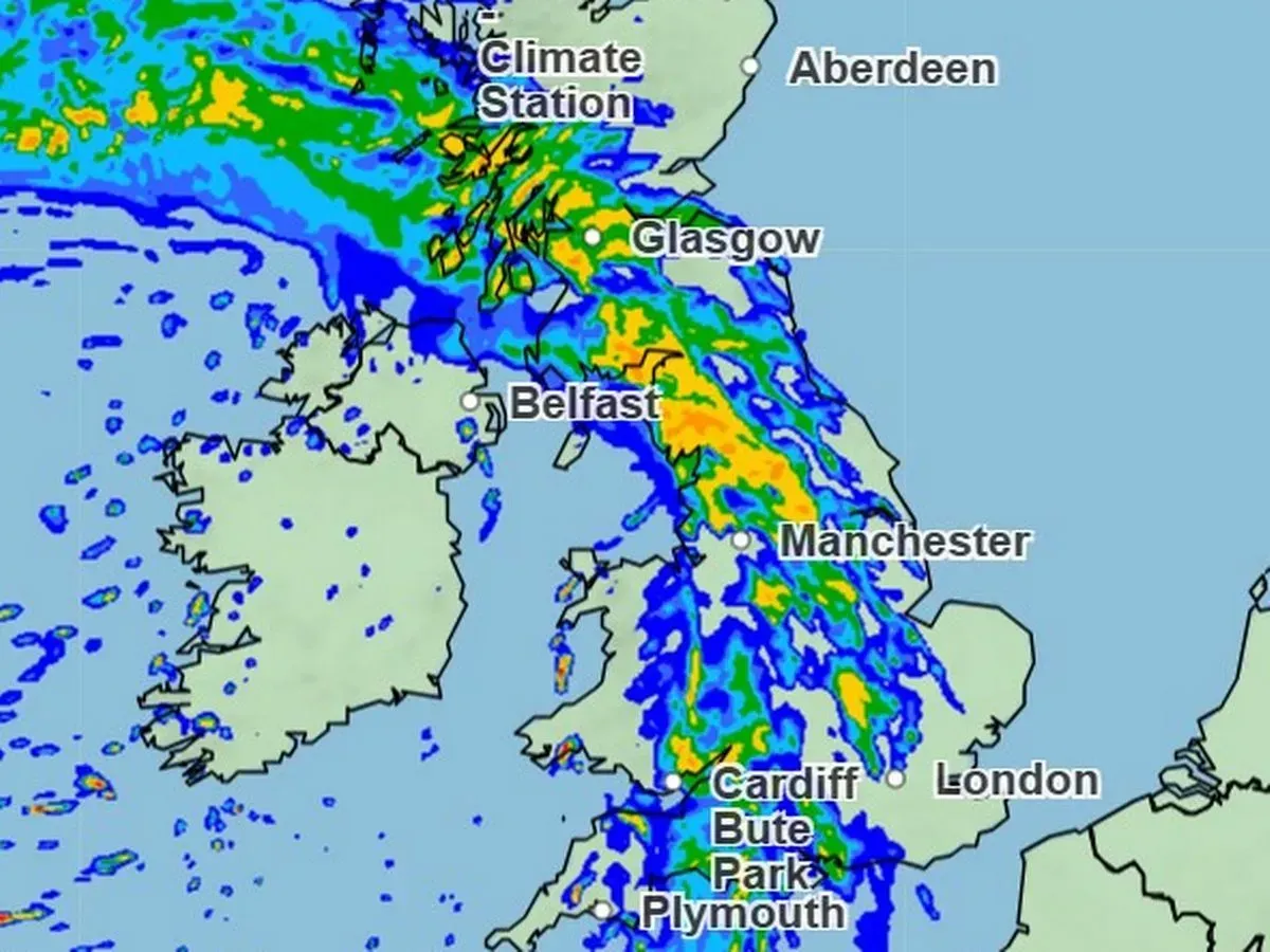 Weather map showing rain over the UK and Ireland. Orange/yellow indicates heaviest rainfall centered over Scotland.