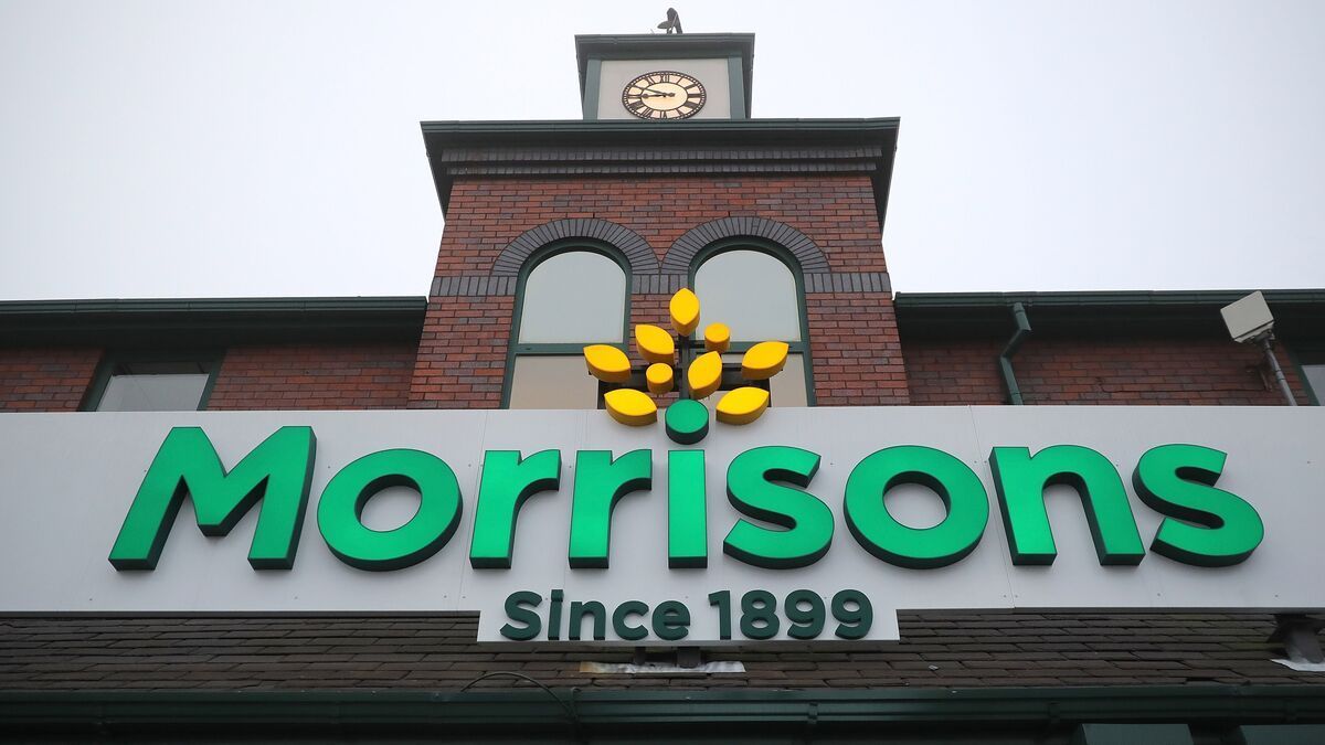 Morrisons supermarket sign with clock tower, green logo, 
