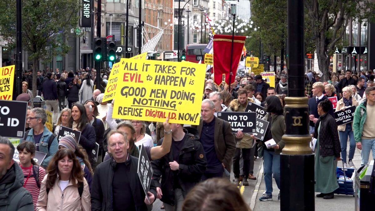 People marching with signs. One sign reads: 