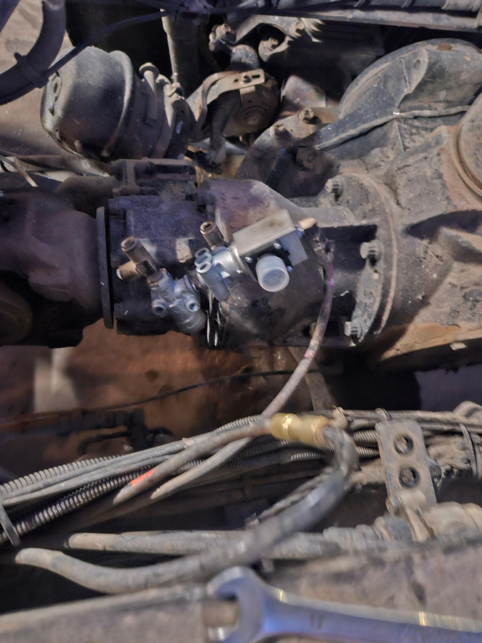Car engine bay with front bumper and components removed for repair.
