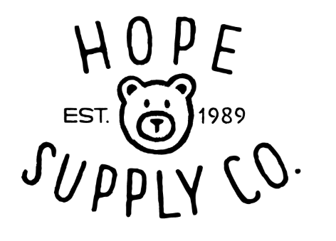 Person cleaning a car's interior with a brush and a flashlight. Inside car, black interior.