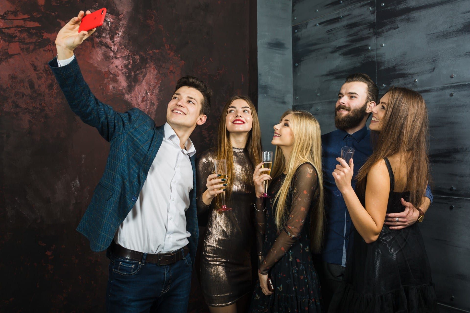 A group of six people taking a selfie at a party.
