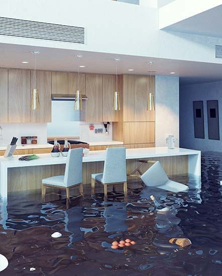 A kitchen with a sink and chairs is flooded with water.