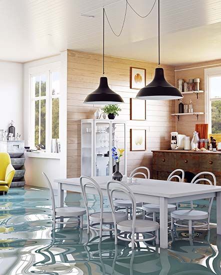 A dining room with a table and chairs and a flooded floor.