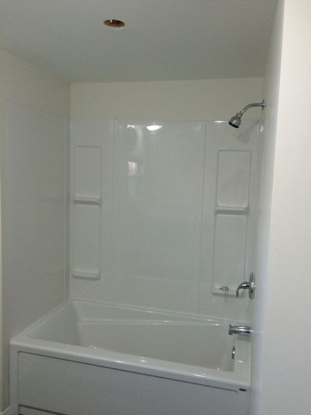 A bathroom with a bathtub and a shower.