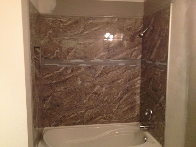 A bathroom with a bathtub and a shower.