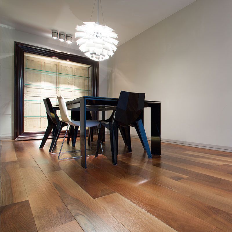 A dining room with a table and chairs and a chandelier