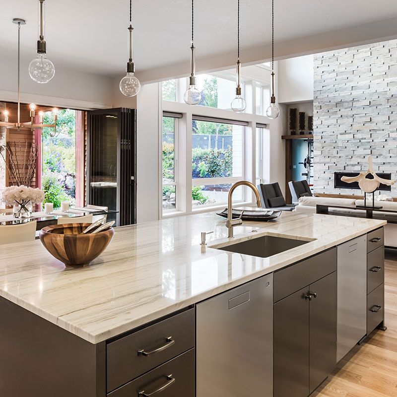 A kitchen with a large island and a sink