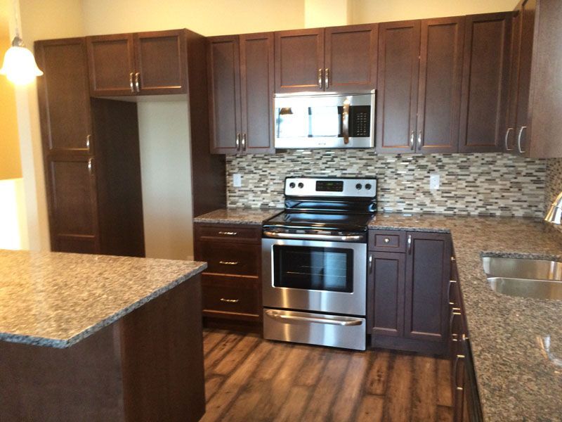 A kitchen with stainless steel appliances and granite counter tops