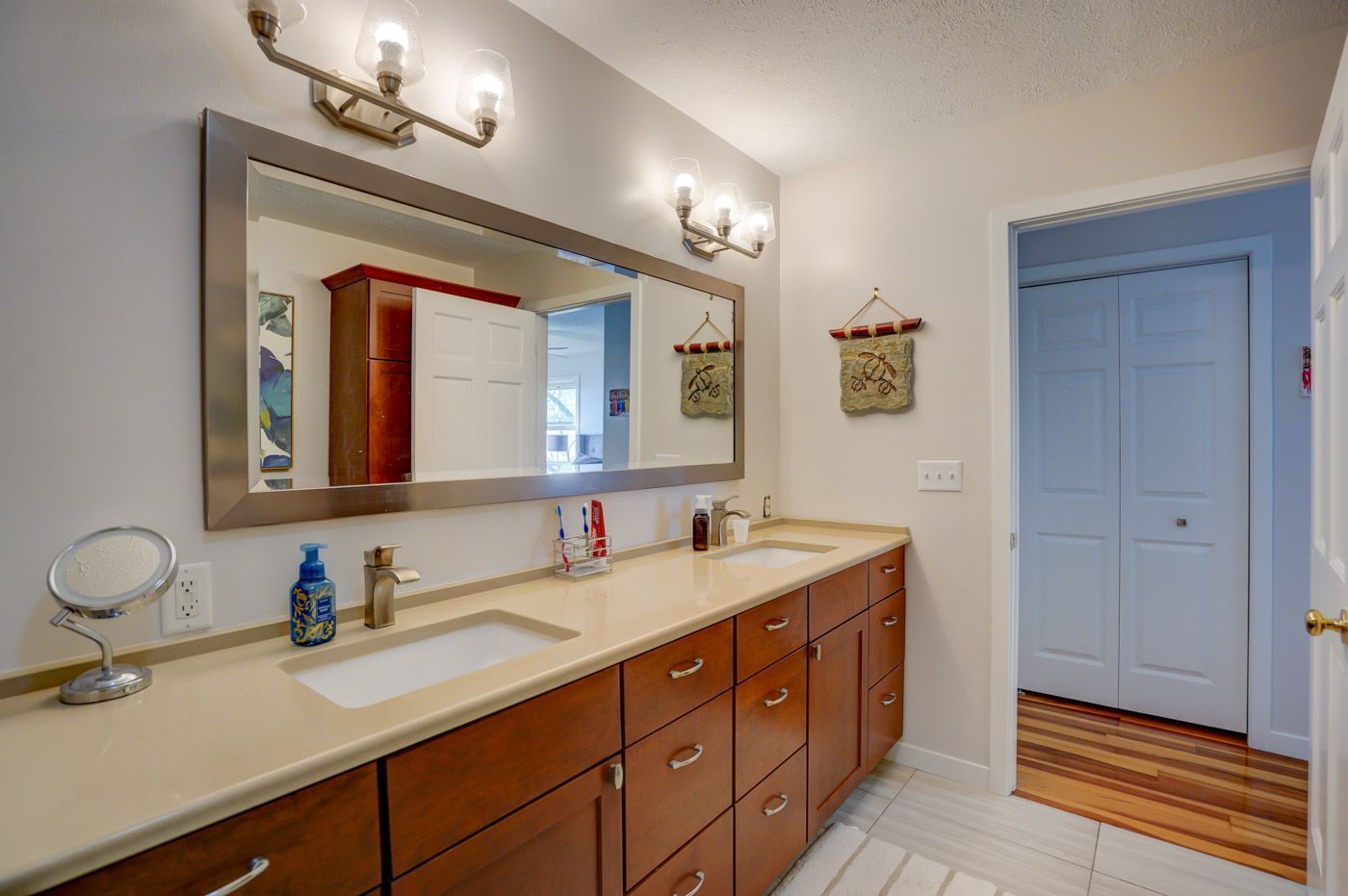 A bathroom with two sinks and a large mirror.