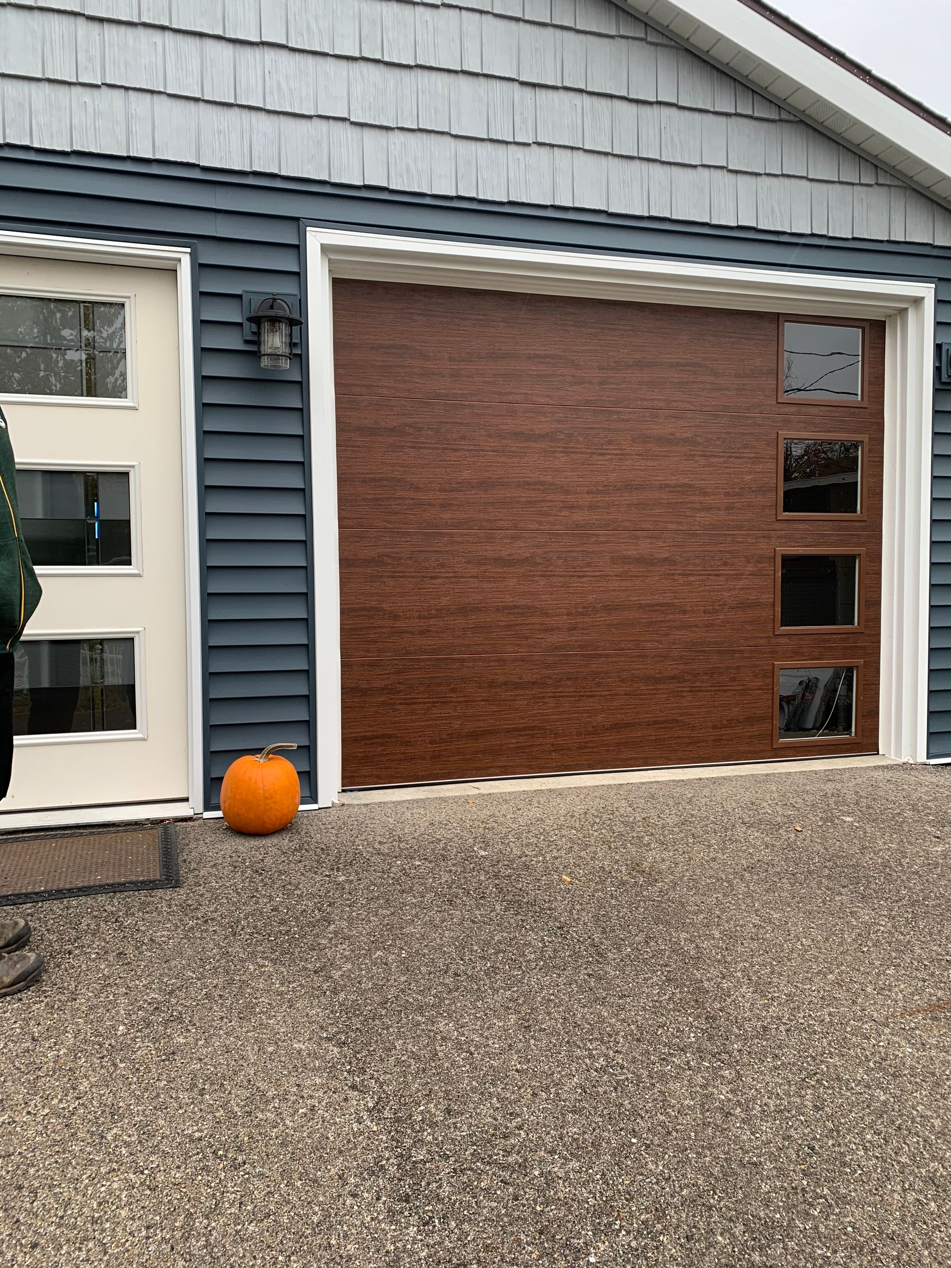 A garage door with a pumpkin in front of it