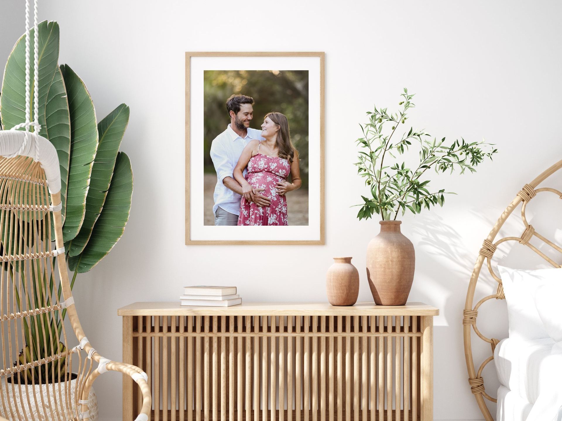 Maternity portrait framed and hanging on the wall in a bright sunny bedroom