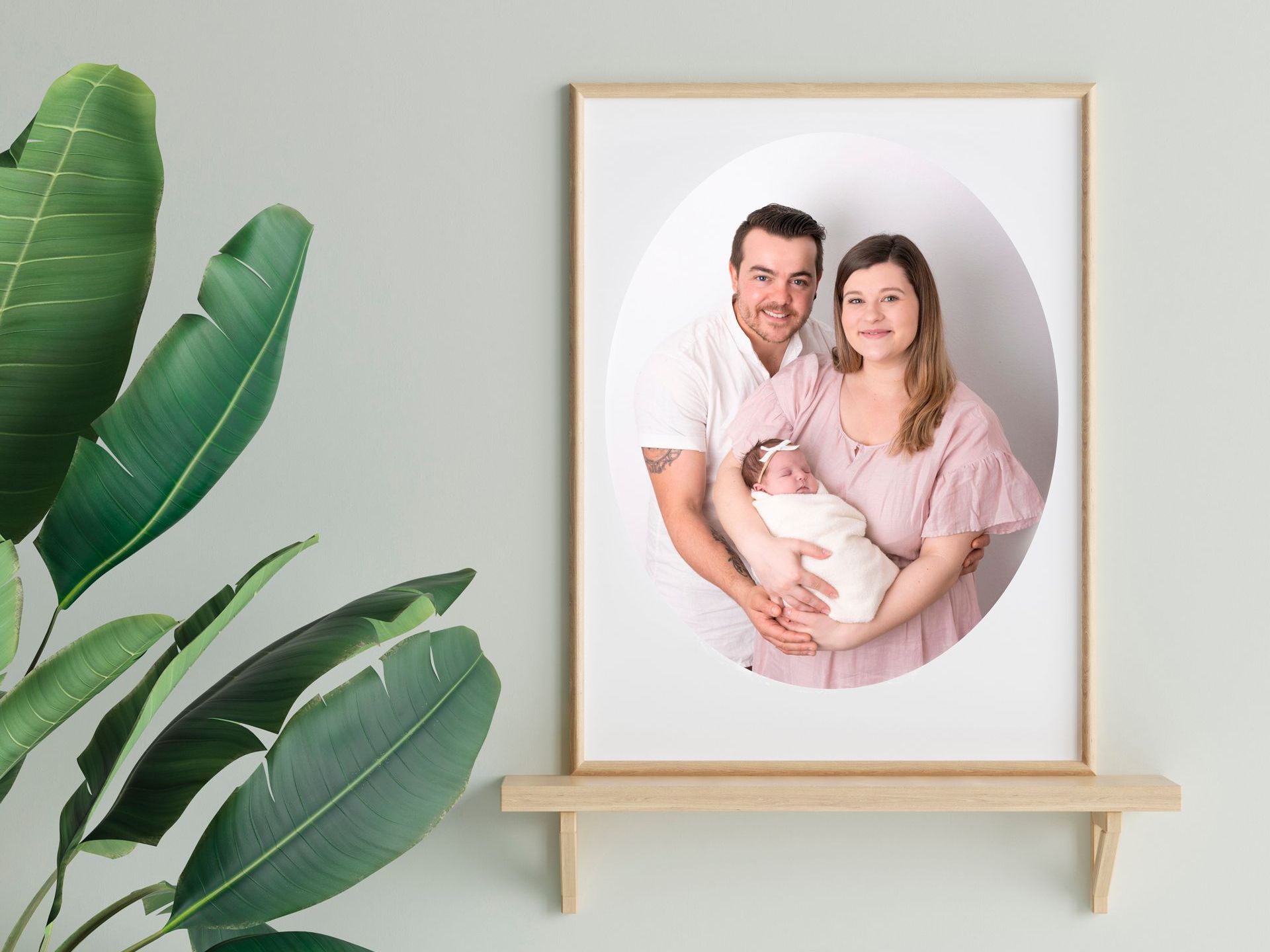 Framed portrait of a young couple holding their baby girl